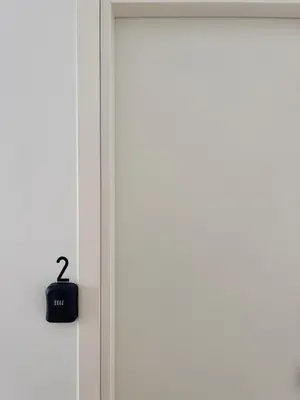 a door with a black alarm clock on it at Sicilia Vacation in San Vito lo Capo