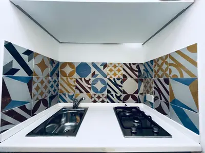 a bathroom with a sink and a counter with colorful tiles at Sicilia Vacation in San Vito lo Capo