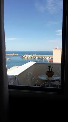 a view from a window of a balcony with a table at La Rosa dei Venti in Isola delle Femmine