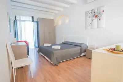a bedroom with a bed and a table and a chair at Casa Gelsomino in Palermo