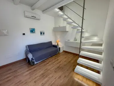 a bedroom with a bed and a stair case at Casa Gelsomino in Palermo