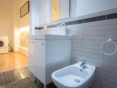 a white bathroom with a sink and a toilet at Casa Gelsomino in Palermo