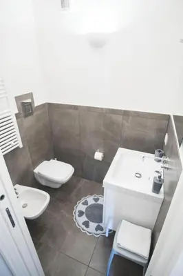 a bathroom with a toilet and a sink at Casa Gelsomino in Palermo