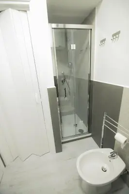 a bathroom with a shower and a toilet and a sink at ArtHouse in San Vito lo Capo