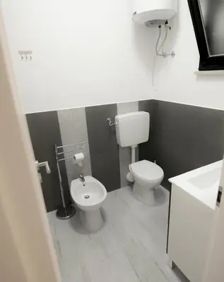 a bathroom with a toilet and a sink at ArtHouse in San Vito lo Capo