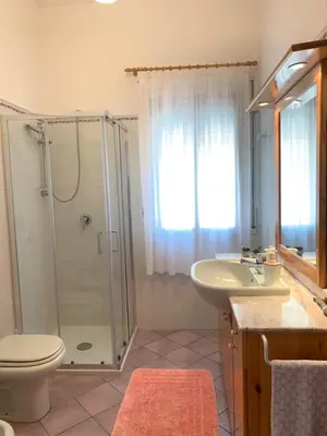 a bathroom with a shower and a toilet and a sink at Villa Cycas Costamante in Castellammare del Golfo