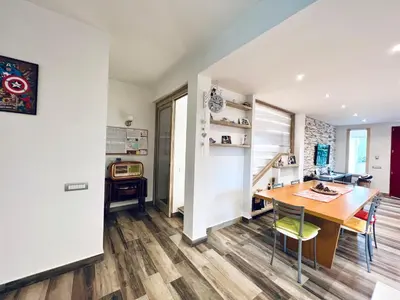 a kitchen and dining room with a wooden table and chairs at Casa di Ivana in Carini