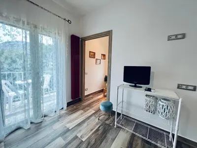 a living room with a television and a large window at Casa di Ivana in Carini