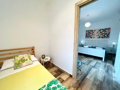 a bedroom with a bed and a mirror at Casa di Ivana in Carini