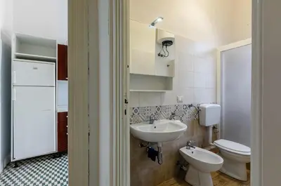 a bathroom with a sink and a toilet at GuestHost - Palermo Central Apartment in Palermo