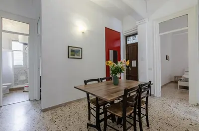 a dining room with a wooden table and chairs at GuestHost - Palermo Central Apartment in Palermo