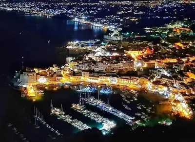 a city at night with boats in a harbor at Villa Plaia in Castellammare del Golfo