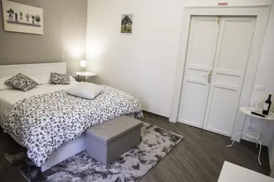 a small bedroom with a bed and a rug at Kalatfimi b&b in Palermo