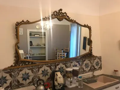 a bathroom with a mirror and a sink at Kalatfimi b&b in Palermo