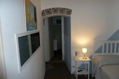 a small bedroom with a bed and a table and a lamp at Kalatfimi b&b in Palermo