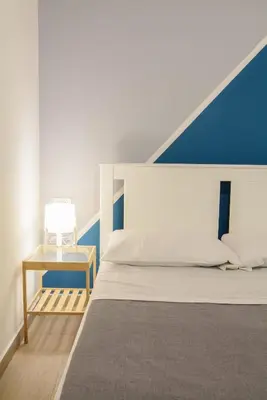 a bedroom with a bed and a side table at Ficodì apartments in Alcamo