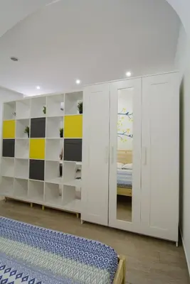 a bedroom with white cabinets and a bed at Ficodì apartments in Alcamo