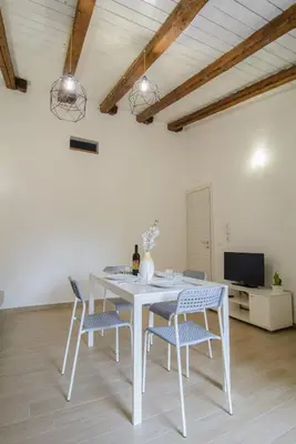 a white table and chairs in a room at Ficodì apartments in Alcamo