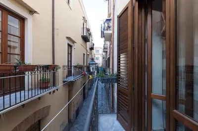 an alley between two buildings in a city at Casetta di Pietre Chico in Palermo