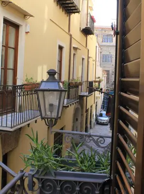 an alley with a street light on a building at Casetta di Pietre Chico in Palermo