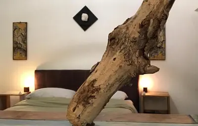 a tree branch sitting on top of a bed at Casetta dei Legni in Palermo