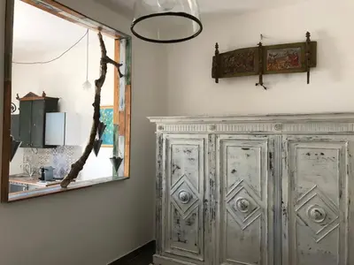 a large wooden cabinet in a kitchen with a mirror at Casetta dei Legni in Palermo