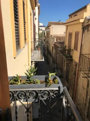 a balcony with a planter with plants on it at Casetta dei Legni in Palermo
