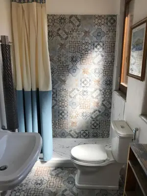 a bathroom with a toilet and a sink and a shower at Casetta dei Legni in Palermo