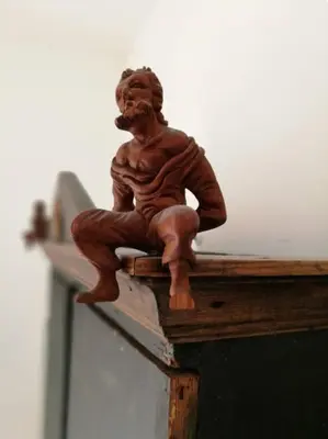 a statue of a man sitting on top of a table at Casetta dei Legni in Palermo