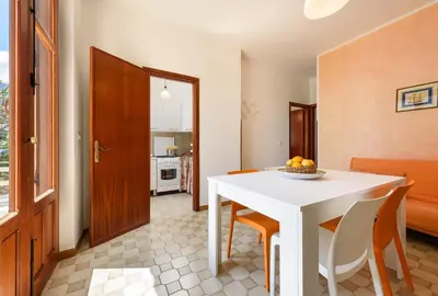 a kitchen and dining room with a white table and chairs at Casa Vacanza Azzurra 3 in San Vito lo Capo