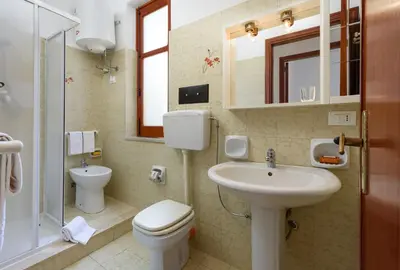 a bathroom with a toilet and a sink at Casa Vacanza Azzurra 3 in San Vito lo Capo