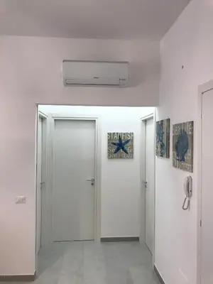 a hallway with a door and a sign on the ceiling at Casa Rosita in San Vito lo Capo