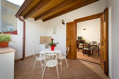 a kitchen and dining room with a table and chairs at Il Sole di Sicilia in Castellammare del Golfo