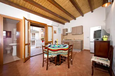 a dining room with a table with a candle on it at Il Sole di Sicilia in Castellammare del Golfo