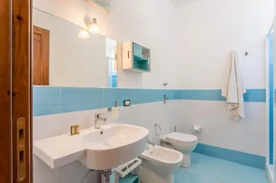 a bathroom with a sink and a toilet at Appartamenti Karma vacanze in Castelluzzo