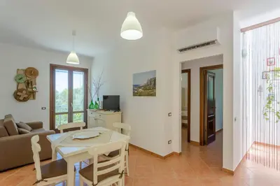 a living room with a couch and a table at Appartamenti Karma vacanze in Castelluzzo