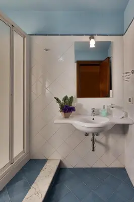 a bathroom with a sink and a mirror at Casa Manzella in Terrasini
