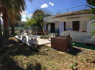 a house with a fence in front of a yard at Casa Manzella in Terrasini