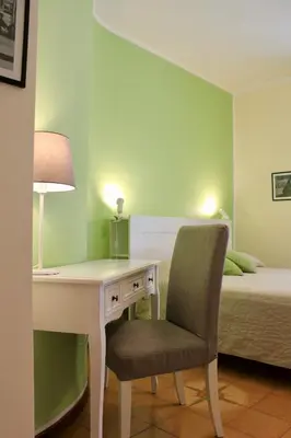 a bedroom with a desk and a bed with a bed gmaxwell gmaxwell gmaxwell at Gli Artisti Apartments & Rooms in Bagheria