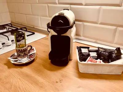 a coffee maker sitting on a counter next to a basket of food at Gli Artisti Apartments & Rooms in Bagheria