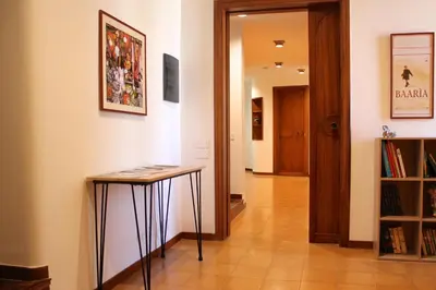 a hallway with a table in the middle of a room at Gli Artisti Apartments & Rooms in Bagheria
