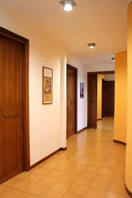 a hallway with doors and a tile floor at Gli Artisti Apartments & Rooms in Bagheria