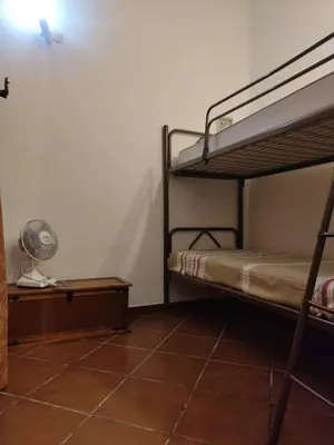 a room with two bunk beds and a fan at Marina in Castellammare del Golfo