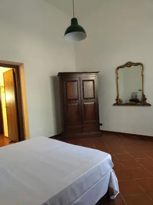 a bedroom with a white bed and a mirror at Marina in Castellammare del Golfo