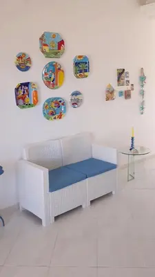 a white room with a table and plates on the wall at Castellammare Holiday in Alcamo Marina