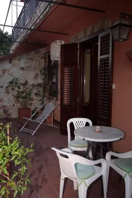 a patio with a table and chairs and stairs at Agriturismo Al Poggetto in Piana degli Albanesi