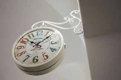 a clock is hanging on a wall at Via Vittorio Emanuele Apartment in Palermo