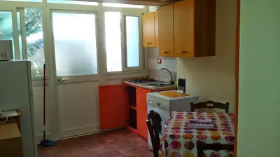 a small kitchen with a table and a stove at vibavacanze in Palermo