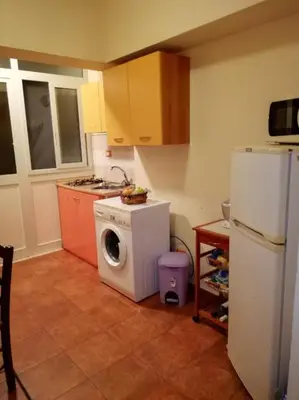 a kitchen with a washing machine and a refrigerator at vibavacanze in Palermo