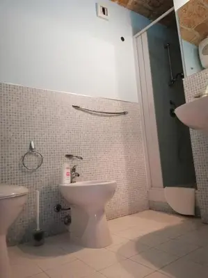 a bathroom with a toilet and a sink at vibavacanze in Palermo